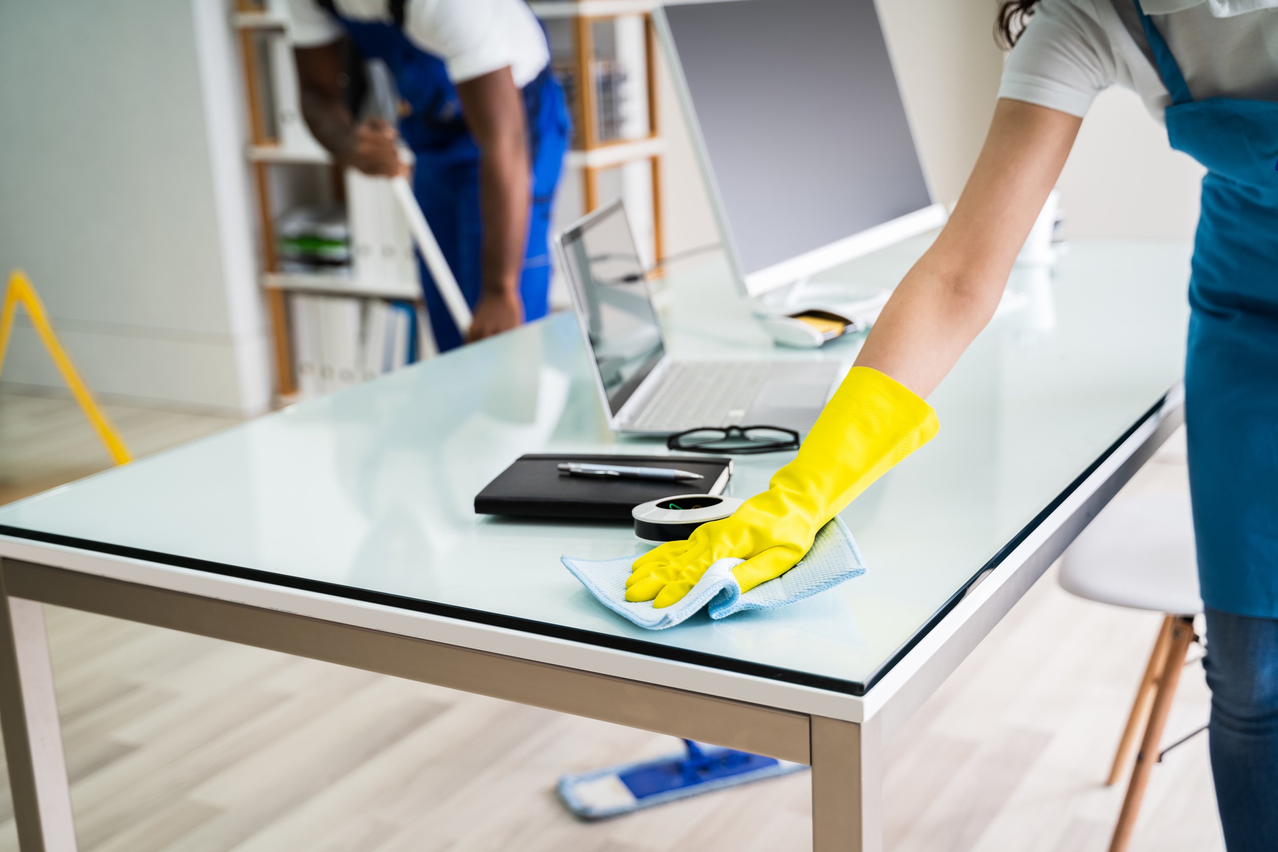 Male And Female Cleaners Cleaning Office